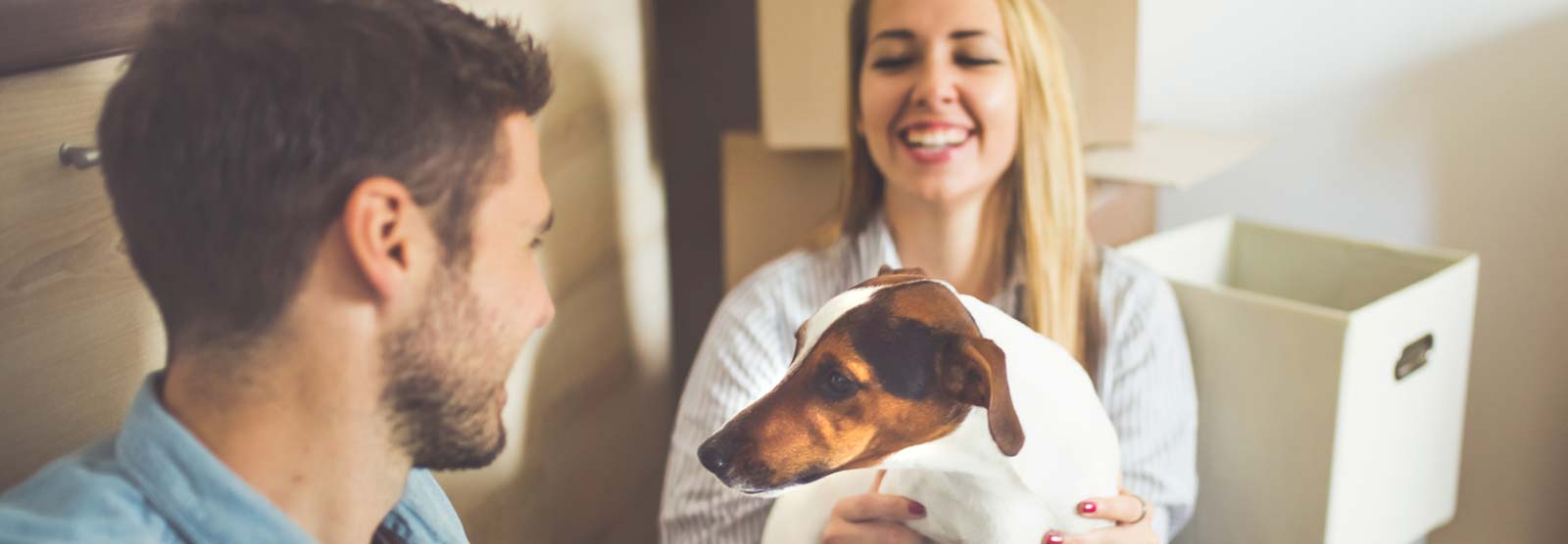 Couple with a dog in a new home